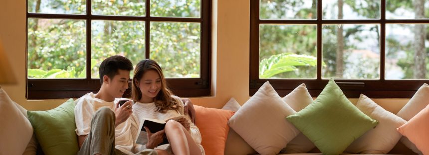 living-room-with-panoramic-windows-romantic-couple-sitting-large-couch-reading-book-together (2)